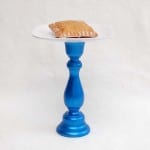 A melamine plate pedestal with a doily and a tart