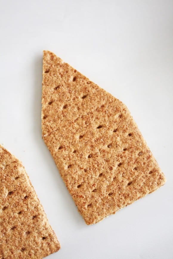 Using a serrated knife, trim the sides of two long pieces of graham cracker. Break one long graham cracker in half. See more party ideas and share yours at CatchMyParty.com
