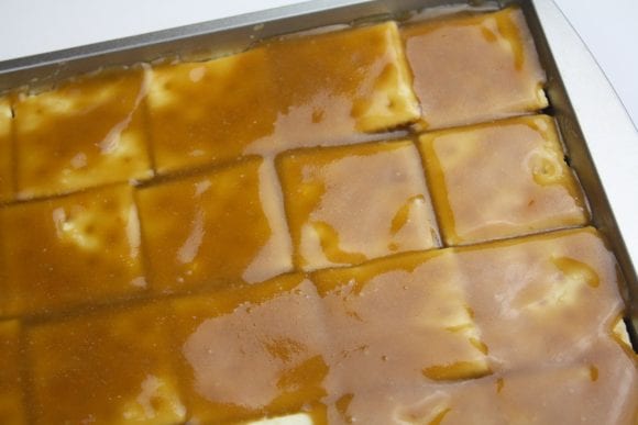 Pour the toffee mixture over the saltine crackers | CatchMyParty.com