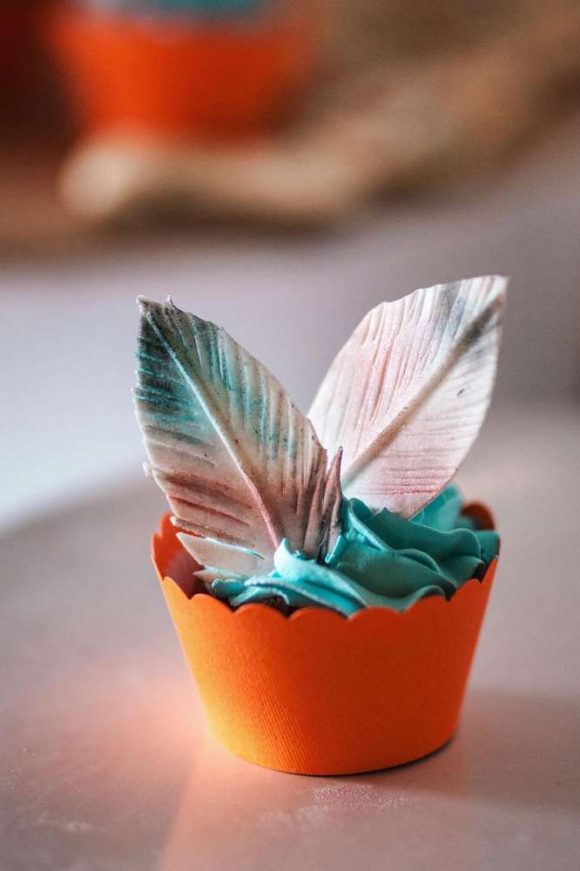 Tribal Cupcakes topped with fondant feathers
