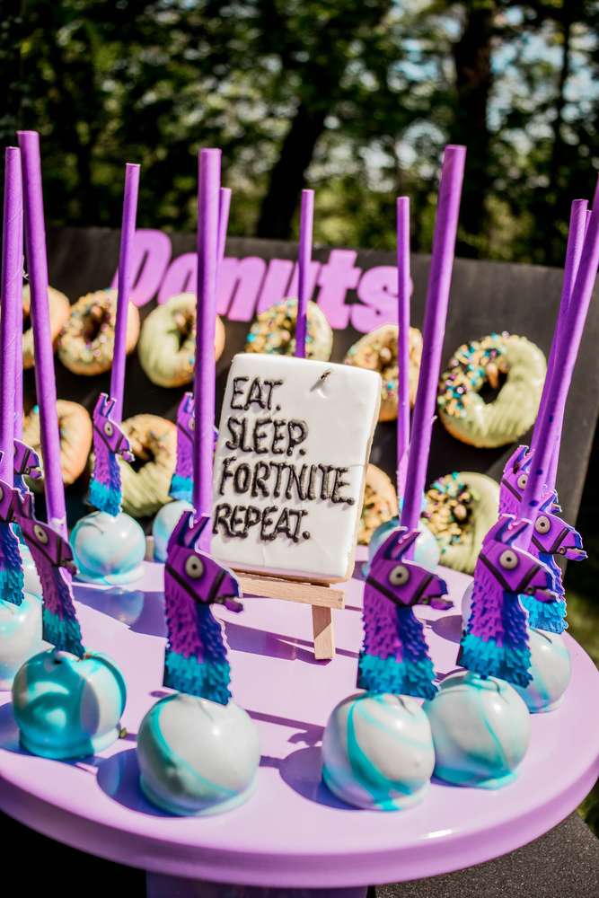 A Fortnite party with fantastic marbled cake pops decorated with pinata llama head cutouts.