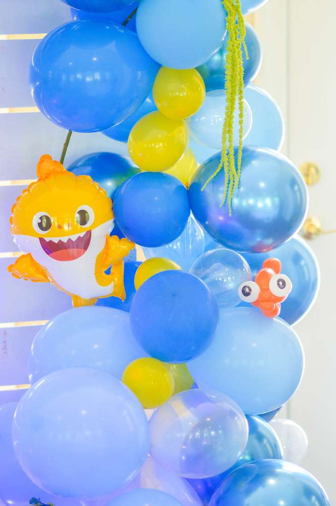 Blue balloon garland with some Baby Shark balloons mixed in