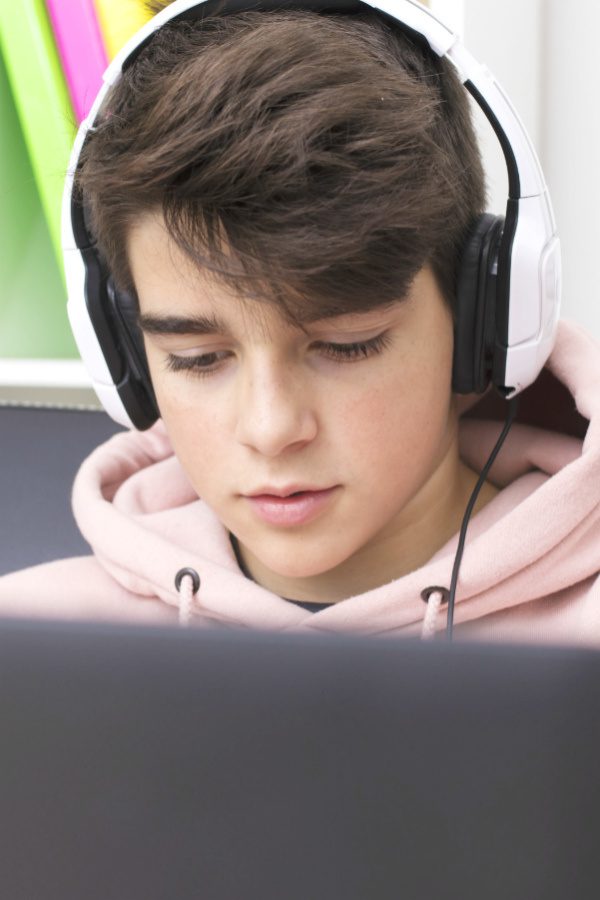 Image of teenage boy on laptop
